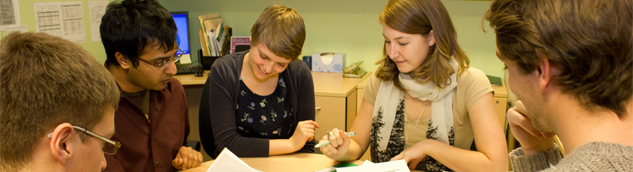 Group of young people working around a table